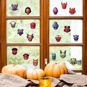 Halloween monster window stickers with pumpkins and candles creating festive home atmosphere