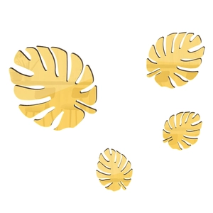 Detailed view of four golden mirror acrylic monstera leaf wall stickers with reflective finish