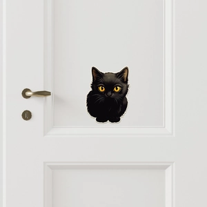 Minimalist black cat wall sticker with yellow eyes on a modern white interior door