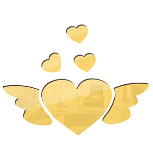 Macro detail of 3D acrylic mirror wall stickers featuring golden heart with wings and small hearts