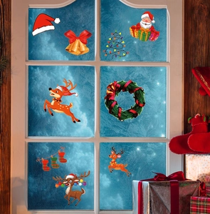 Close-up of Christmas window stickers with Santa, reindeer and gifts on glass