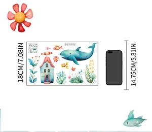 Luminous ocean wall stickers with blue whale and glowing fish next to phone for scale