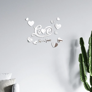 Detail of silver mirror acrylic Love and heart wall stickers on a modern grey wall