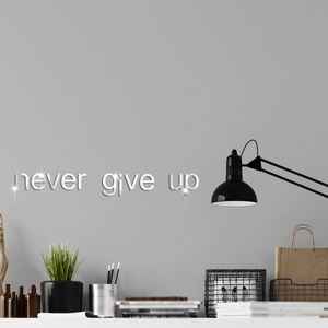 Detail showing Never Give Up mirrored wall decal with silver reflective surface in modern room