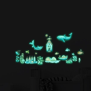 Glow in the dark ocean themed wall stickers featuring whales and sea plants in blue light