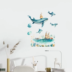 Detail of nautical glow-in-the-dark stickers showing a whale and dolphin on a study wall
