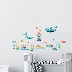 Detailed view of watercolor ocean theme wall stickers with blue whales in a kids bedroom