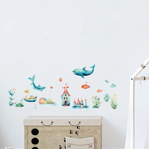 Detailed view of watercolor ocean fish wall stickers in a cozy children's nursery room
