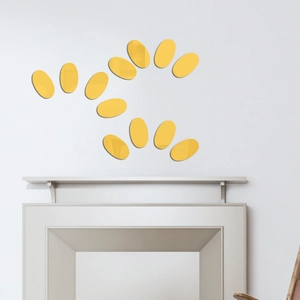 Modern wall decor featuring 12 yellow oval acrylic mirror stickers arranged over a mantel