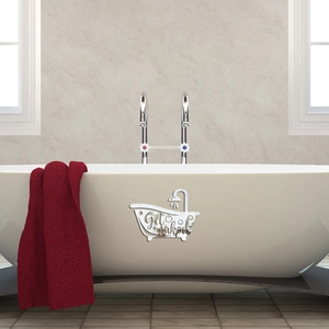 Close-up of silver acrylic mirror wall sticker with Get Naked text on a white bathtub