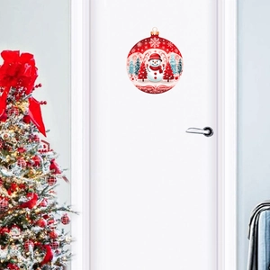Festive round Christmas wall sticker with cute snowman and red trees on a white door