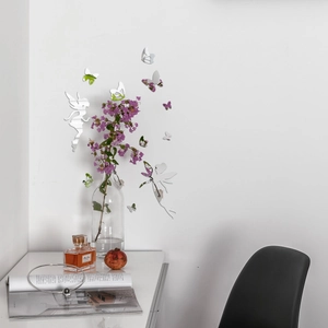 Mirror fairy and butterflies acrylic wall stickers reflecting light on a white room wall