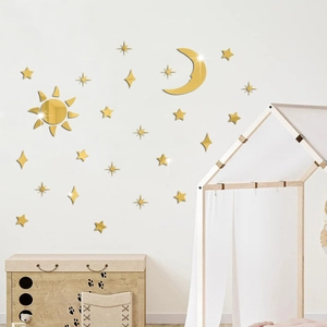 Detail of gold mirror acrylic sun moon stars wall stickers in a cozy nursery room setting