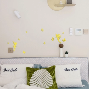 Detail of yellow acrylic 3D wall stickers featuring fairies and butterflies in a bedroom