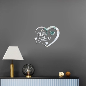 Detail view of 1mm mirrored acrylic heart wall decal with I Love You lettering on grey wall