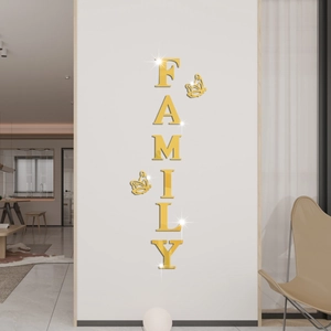 Close-up of golden acrylic mirror wall stickers featuring FAMILY letters and butterflies