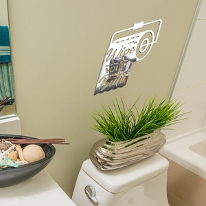 Detail of silver acrylic mirror wall sticker with funny 'Wipe your Butt' quote for bathroom