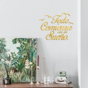 Detail of gold mirror acrylic wall decal featuring Spanish quote with bird shapes