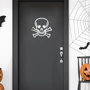 Detail of silver mirror acrylic skull sticker on a black door with Halloween decorations