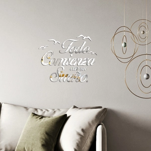 Detail of silver acrylic mirror wall sticker with inspirational Spanish quote and birds