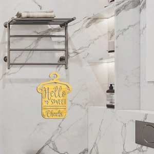 Golden acrylic mirror wall decor Hello Sweet Cheeks on white marble bathroom tiles