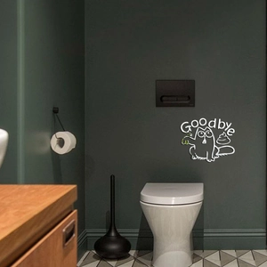 Detail showing white cartoon cat sticker with Goodbye text on green bathroom wall