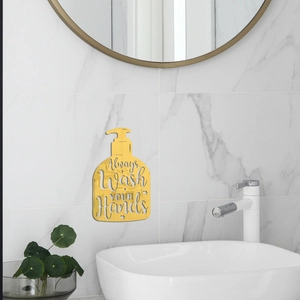 Detail showing golden acrylic bottle sticker with Always Wash Your Hands text on marble wall