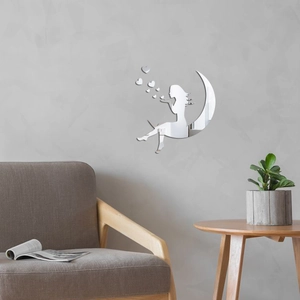 Detail of silver acrylic moon girl mirror wall sticker on modern living room wall