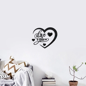 Detail of black acrylic heart wall sticker featuring I love you design on white living room wall