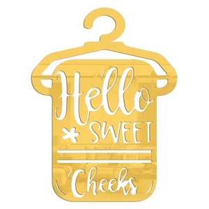 Close-up of golden mirror acrylic wall decor featuring Hello Sweet Cheeks cutout design