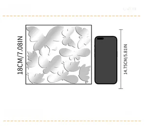 Size comparison of 3D butterfly mirror wall stickers next to a smartphone