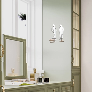 Close-up of modern acrylic mirror signs for bathroom doors with ladies and gents silhouettes