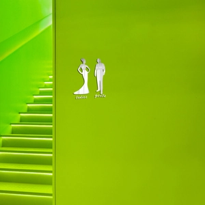 Silver mirror acrylic restroom signs for ladies and gents on a green wall