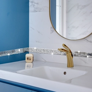 Macro detail of silver acrylic mirror wall stickers with Greek meander geometric pattern