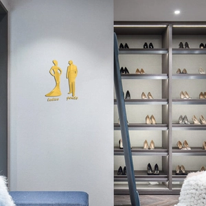 Macro detail of gold acrylic mirror wall stickers with ladies and gents silhouettes