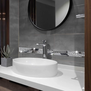 Detail of silver mirror Greek key acrylic wall border sticker in a modern bathroom