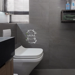 Detailed view of white minimalist hippo acrylic wall sticker on a gray bathroom tile wall