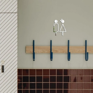 Detailed mirror acrylic restroom sign with reflective silver finish on gray wall