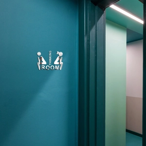 Detail of silver acrylic Thinking Room door sign with 3D mirror finish on a dark wall