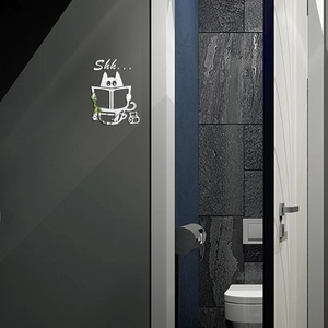 Detail of silver acrylic mirror wall sticker with a cartoon cat reading on a grey door