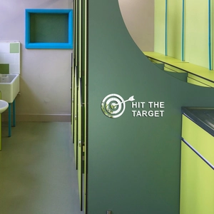 Macro view of silver acrylic mirror wall decal featuring Hit The Target slogan