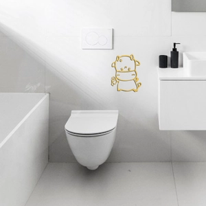 Detail of mirror gold acrylic cartoon cow wall sticker in a modern white bathroom