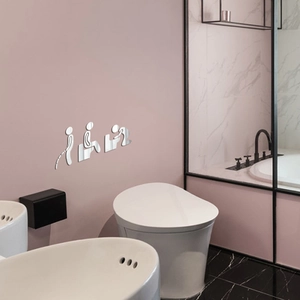 Macro detail of 3D acrylic mirror wall stickers showing funny bathroom figures on pink wall