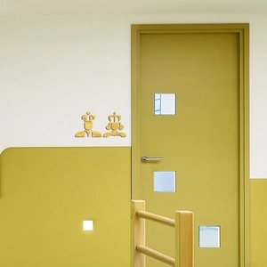 Detail of 3D gold mirror acrylic restroom door signs with king and queen crown icons