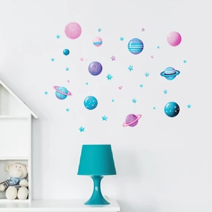 Detail of glow-in-the-dark cartoon space planets and stars wall stickers in a nursery
