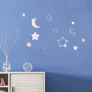Star and moon mirrored acrylic wall stickers on dark blue wall with home decor