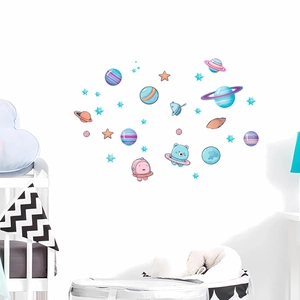 Detailed view of luminous space stickers with colorful planets and astronauts on nursery wall