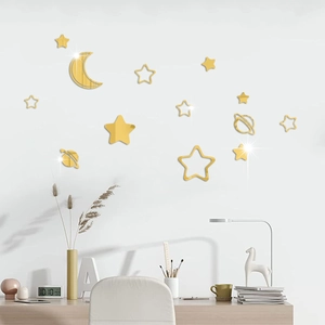 Detailed view of gold mirror acrylic moon and stars wall stickers in a modern room setting