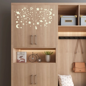 Luminous stars and moon wall stickers set on a wooden cabinet for bedroom decor