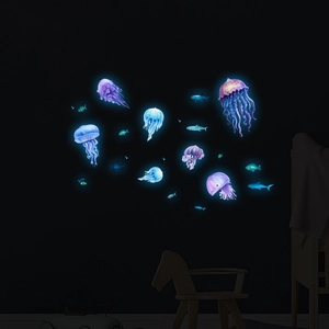 Luminous jellyfish and fish wall stickers glowing in a dark themed children bedroom